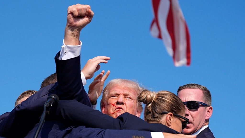 Trump enters the stage in a quiet manner.